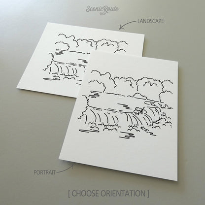 Two line art drawings of Katmai National Park on white linen paper with a gray background.  The pieces are shown in portrait and landscape orientation for the available art print options.