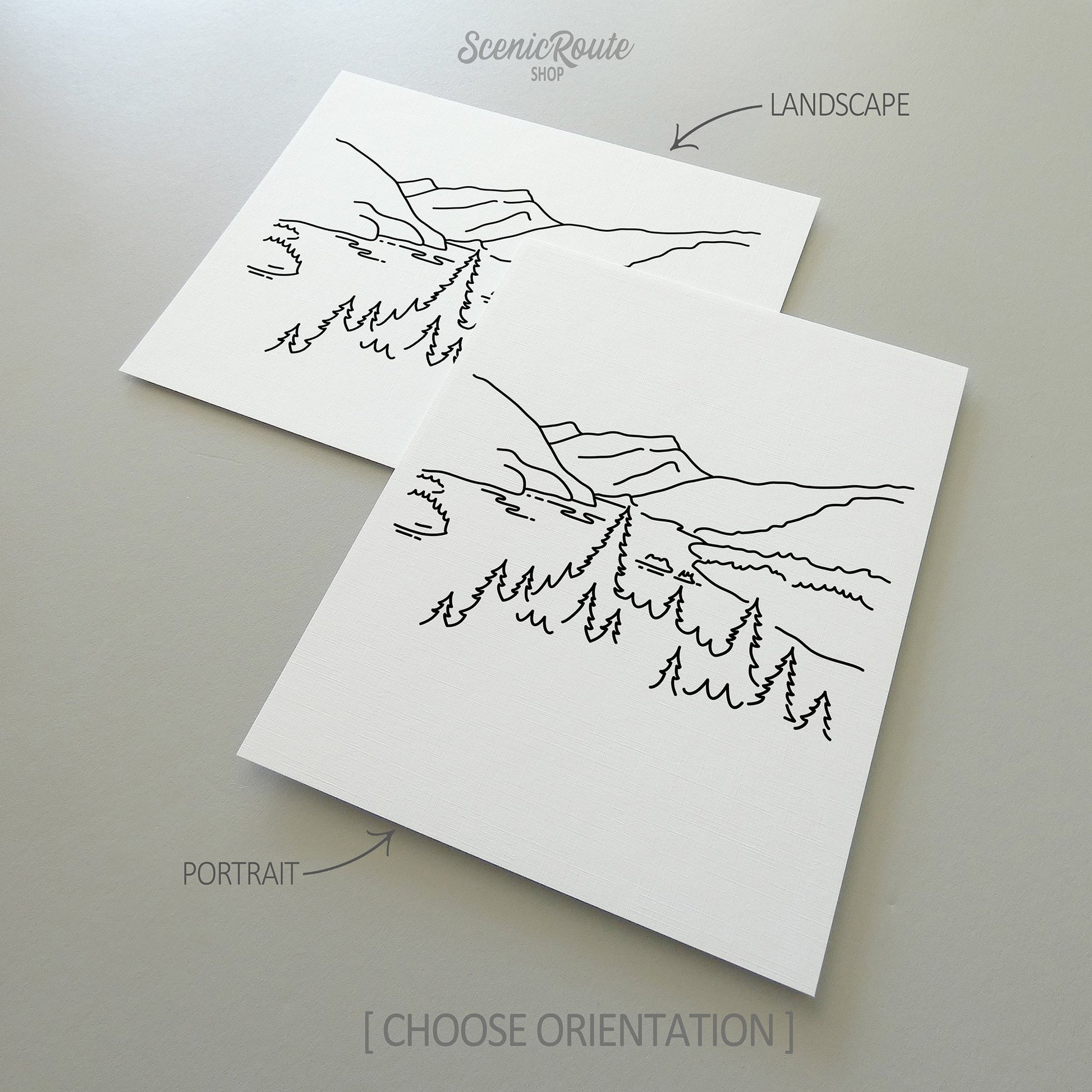 Two line art drawings of North Cascades National Park on white linen paper with a gray background.  The pieces are shown in portrait and landscape orientation for the available art print options.