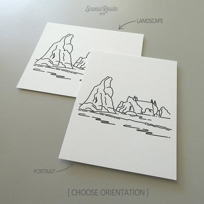 Two line art drawings of Olympic National Park on white linen paper with a gray background.  The pieces are shown in portrait and landscape orientation for the available art print options.