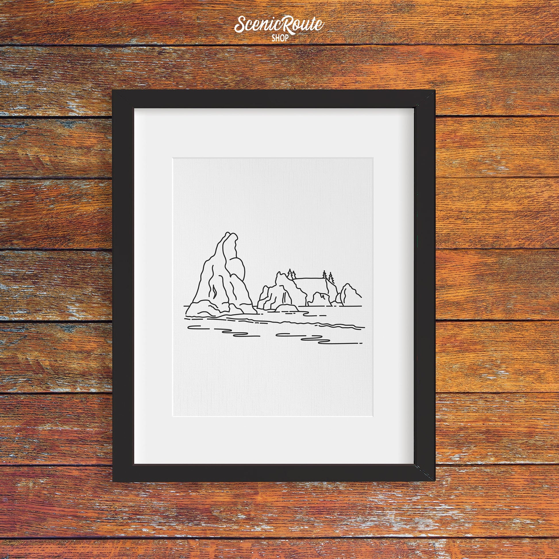 A framed line art drawing of Olympic National Park on a wood wall