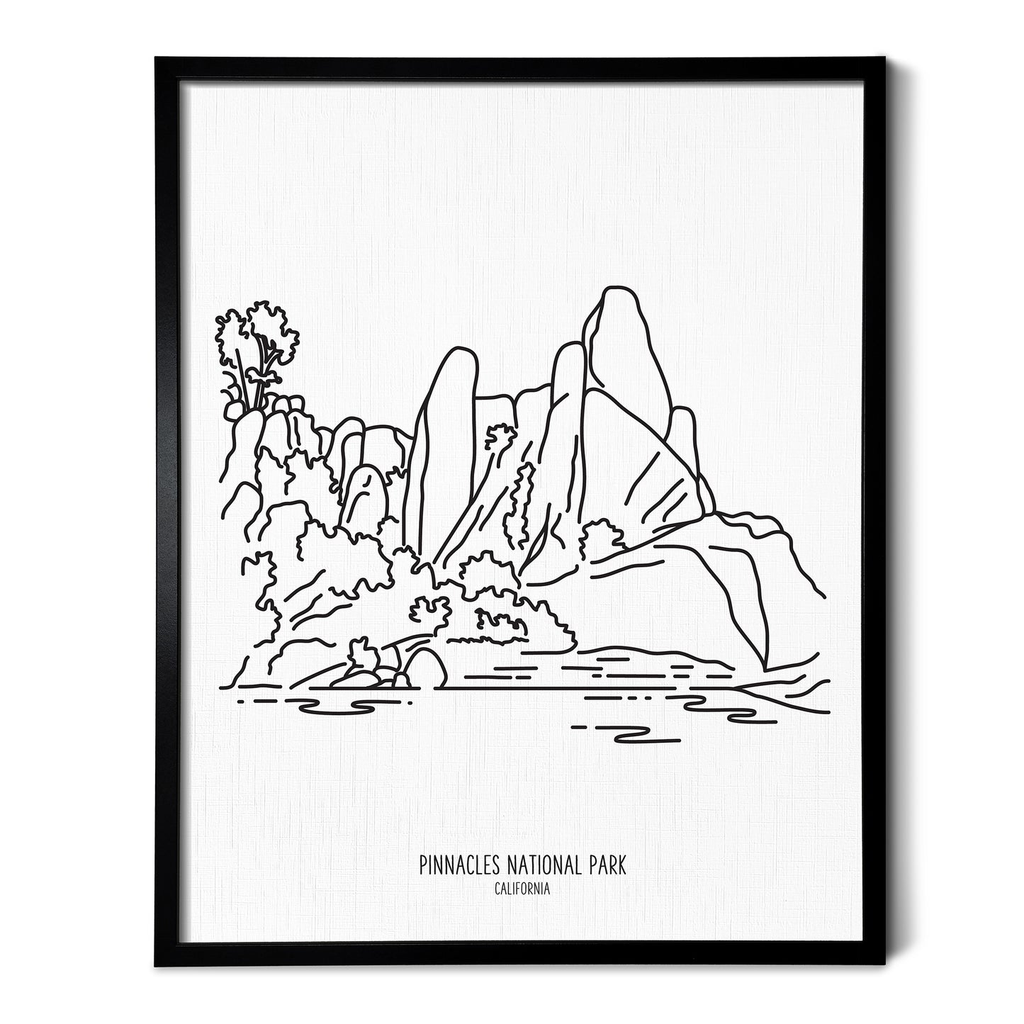 A line art drawing of Pinnacles National Park on white linen paper in a thin black picture frame