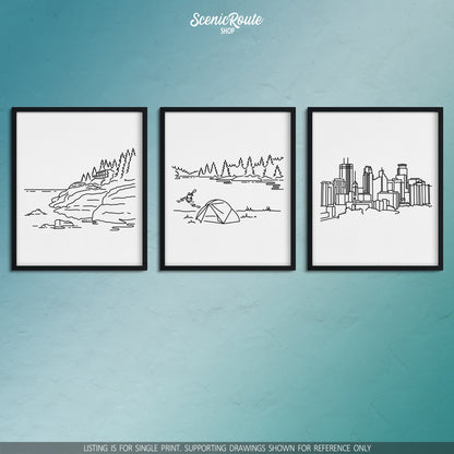 A group of three framed drawings on a blue wall. The line art drawings include Isle Royale National Park, Voyageurs National Park, and the Minneapolis Skyline