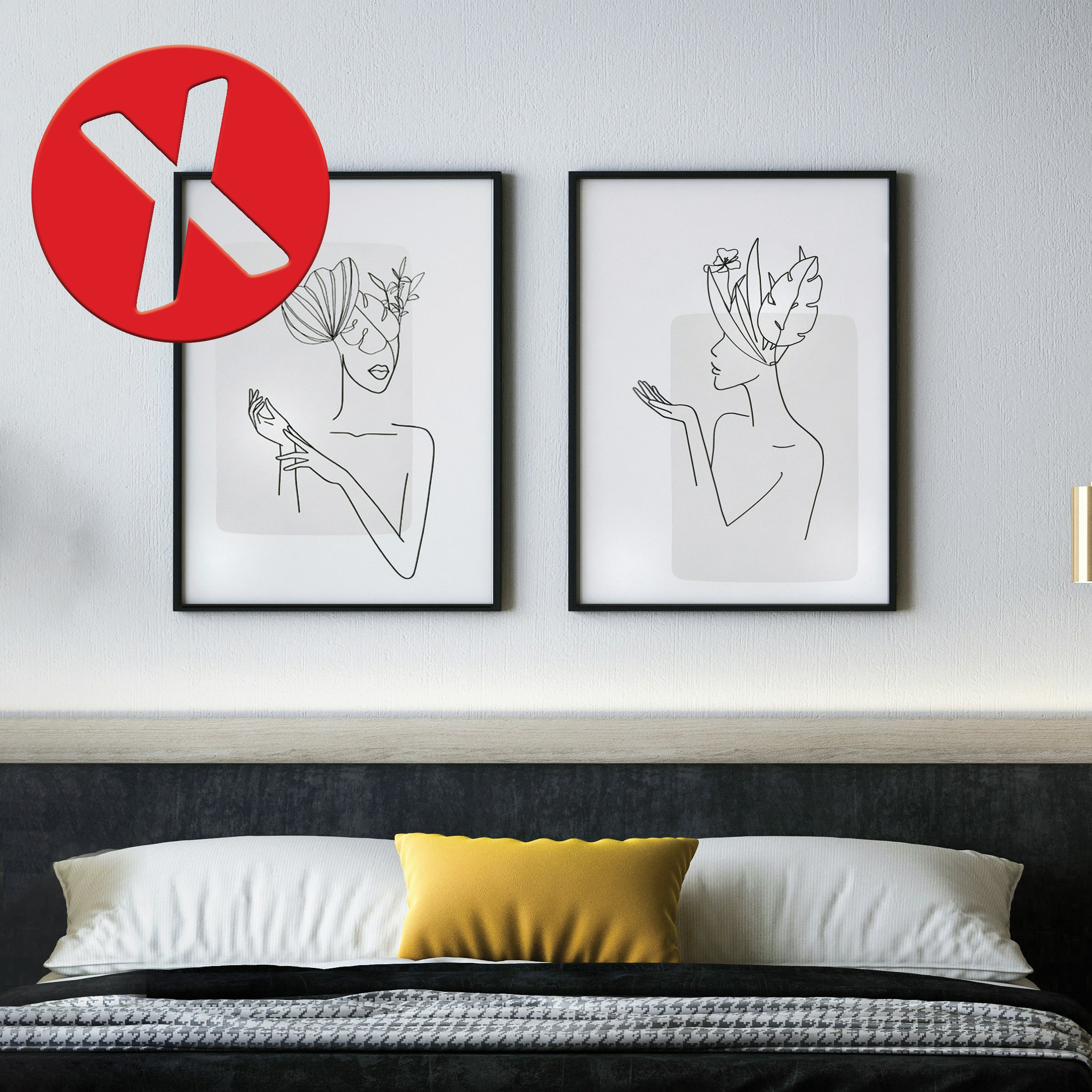 two framed drawings hanging over a bed