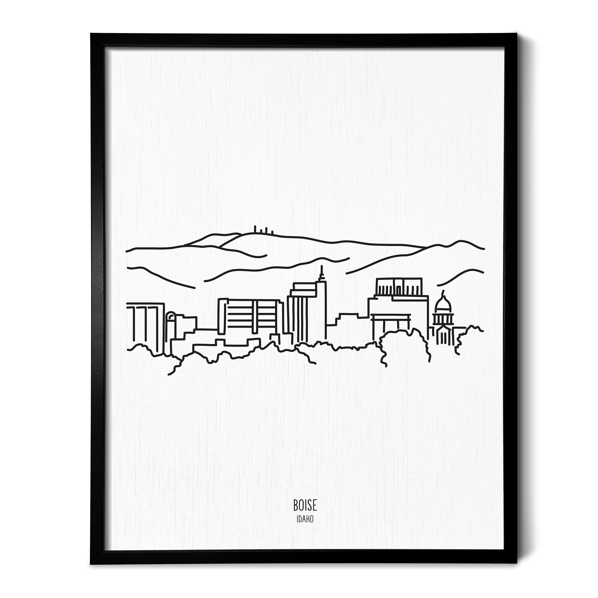 A line art drawing of the Boise Idaho Skyline on white linen paper in a thin black picture frame