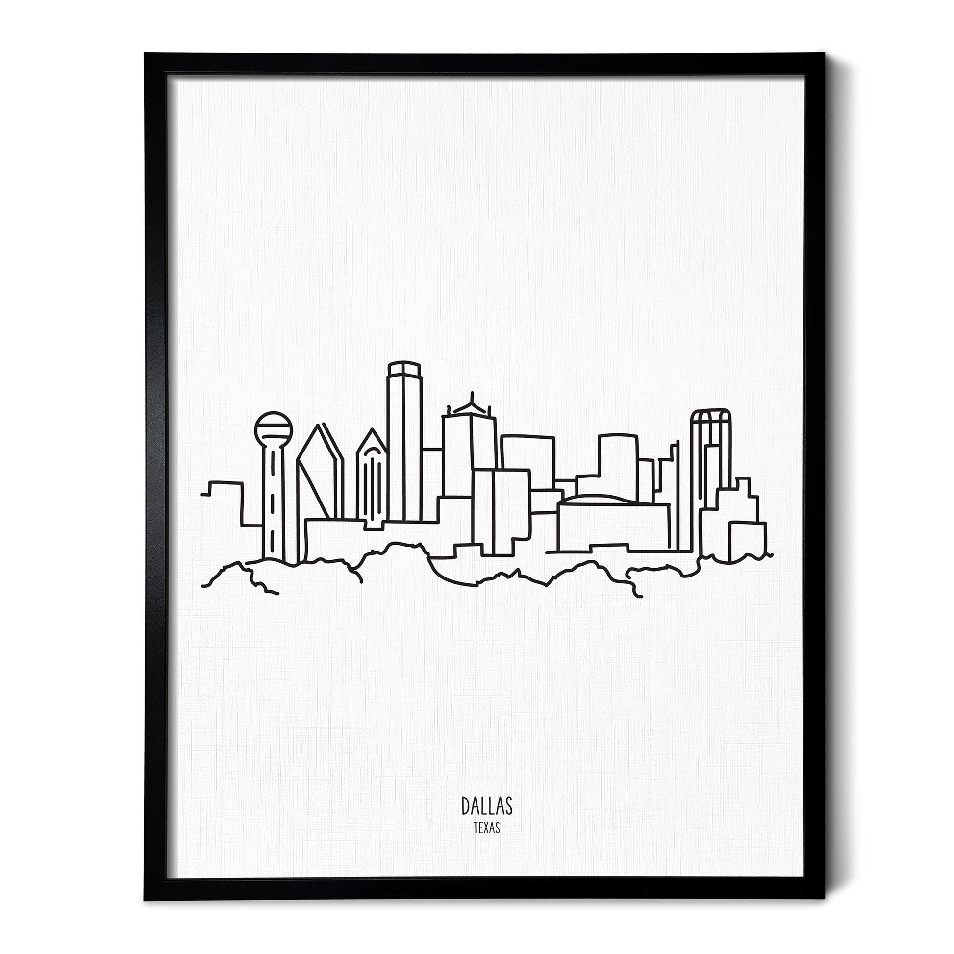 A line art drawing of the Dallas Texas Skyline on white linen paper in a thin black picture frame