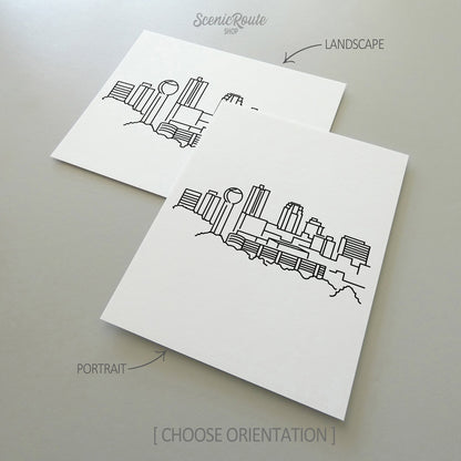 Two line art drawings of the Knoxville Skyline on white linen paper with a gray background.  The pieces are shown in portrait and landscape orientation for the available art print options.