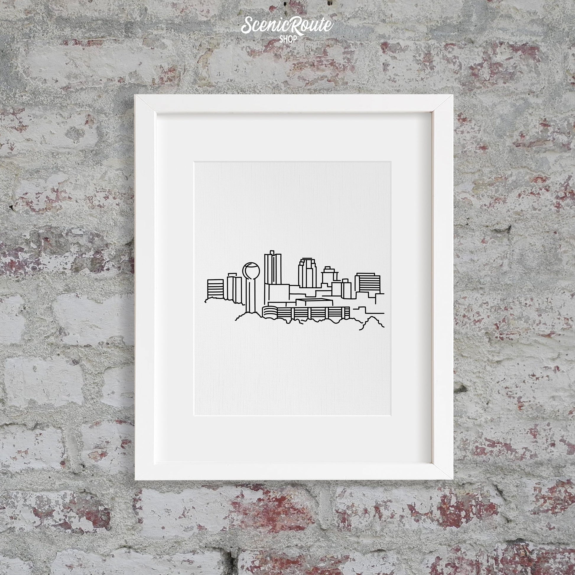 A framed line art drawing of the Knoxville Skyline on a brick wall