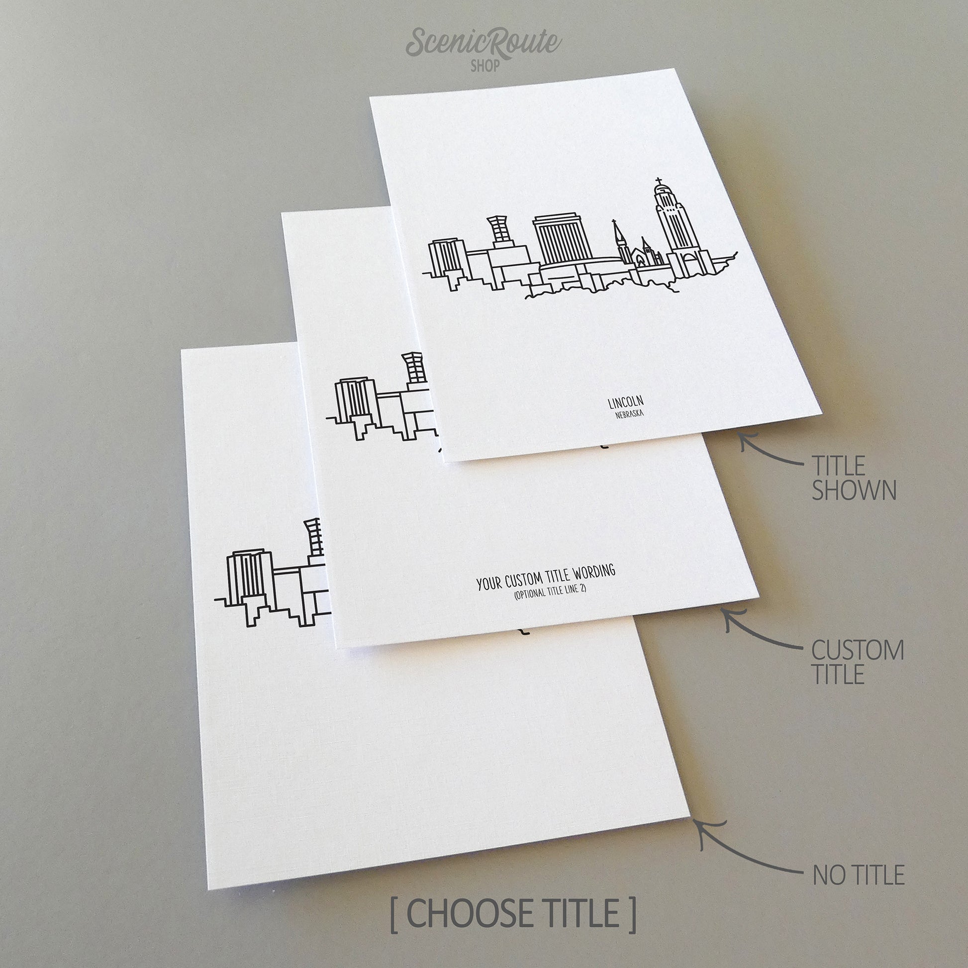 Three line art drawings of the Lincoln Nebraska Skyline on white linen paper with a gray background. The pieces are shown with title options that can be chosen and personalized.