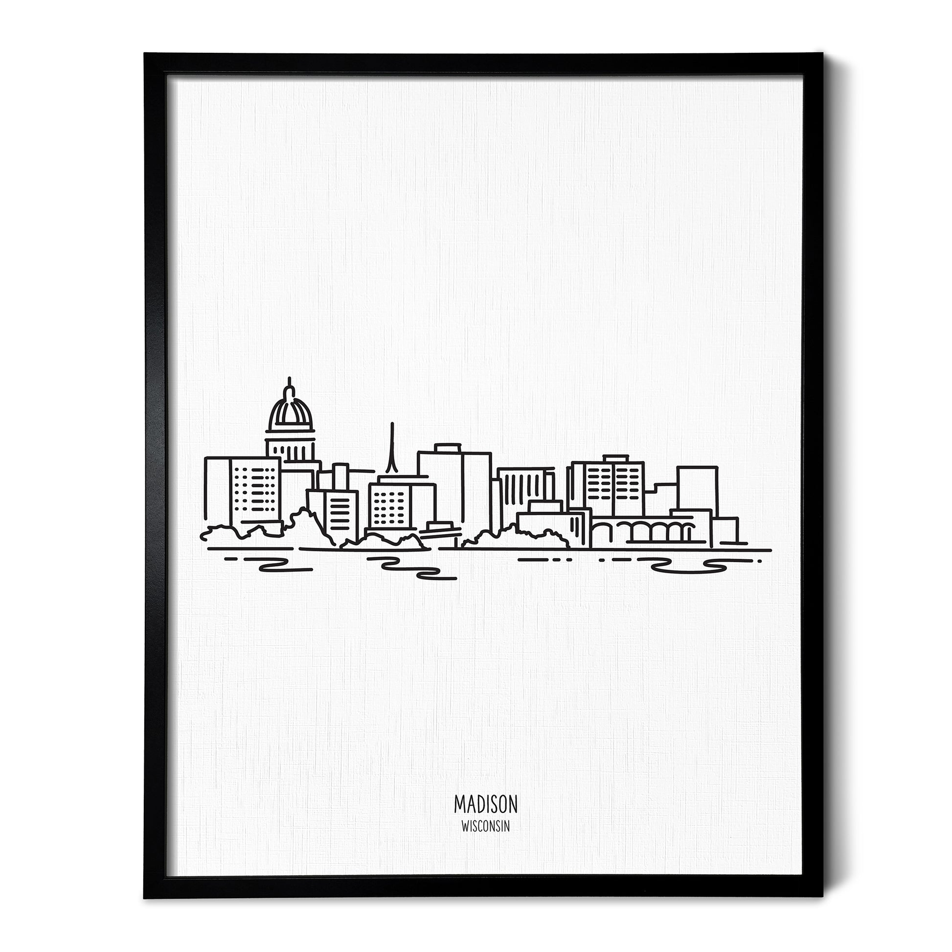 A line art drawing of the Madison Wisconsin Skyline on white linen paper in a thin black picture frame