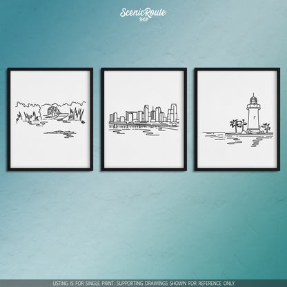 A group of three framed drawings on a blue wall. The line art drawings include the Everglades National Park, Miami Skyline, and Biscayne National Park