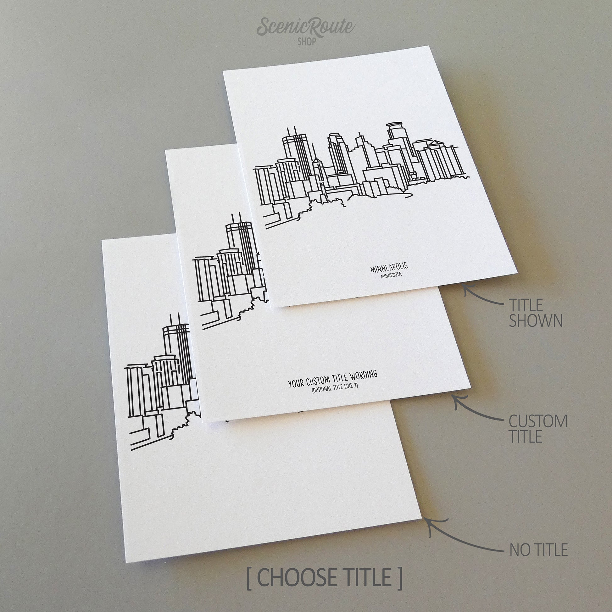 Three line art drawings of the Minneapolis Minnesota Skyline on white linen paper with a gray background. The pieces are shown with title options that can be chosen and personalized.