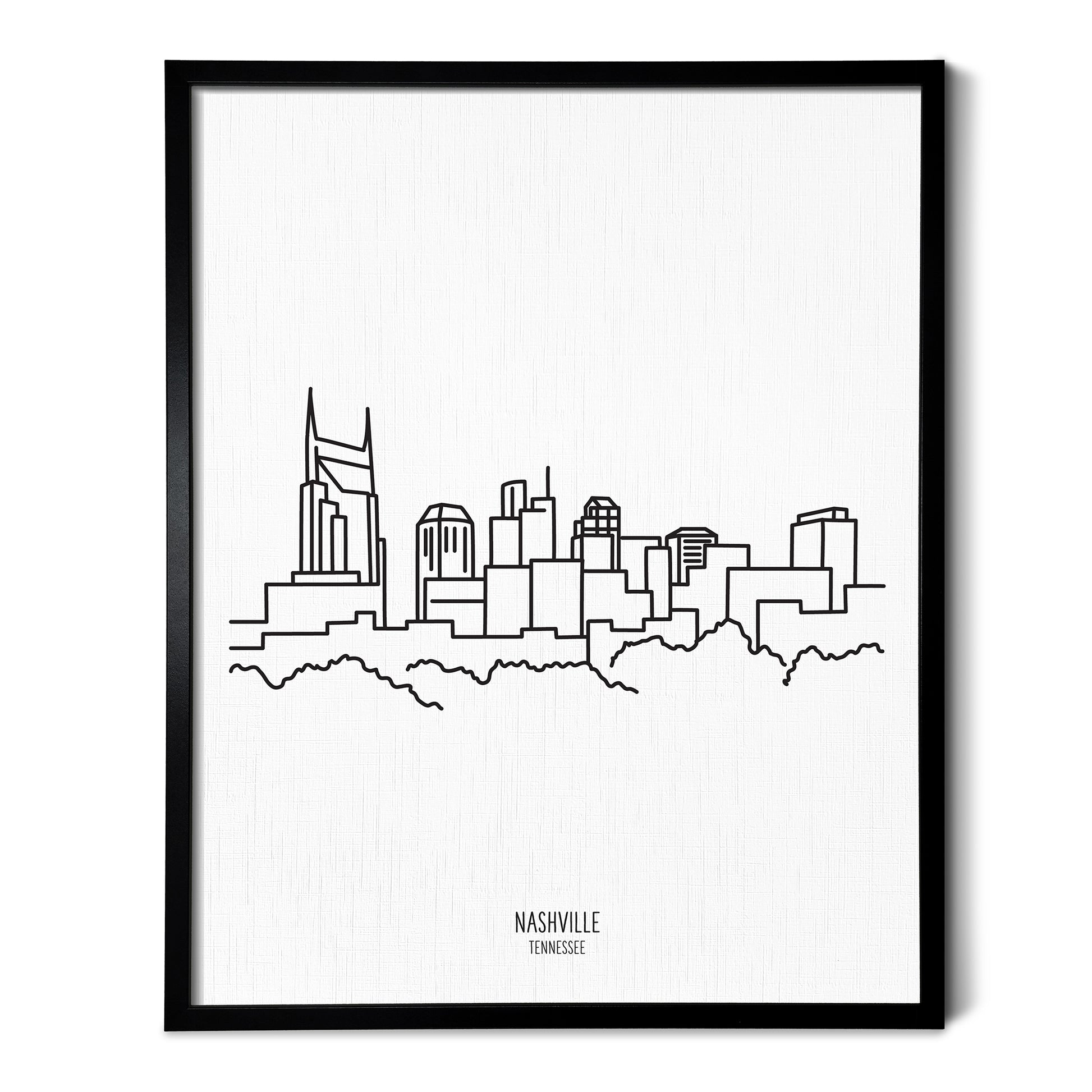 A line art drawing of the Nashville Tennessee Skyline on white linen paper in a thin black picture frame