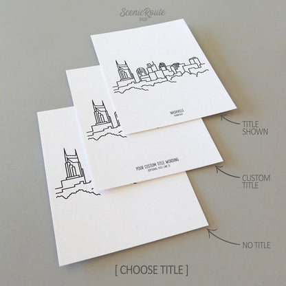 Three line art drawings of the Nashville Tennessee Skyline on white linen paper with a gray background. The pieces are shown with title options that can be chosen and personalized.