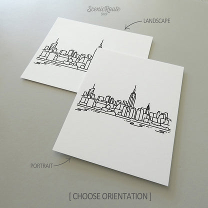 Two line art drawings of the New York City Skyline on white linen paper with a gray background.  The pieces are shown in portrait and landscape orientation for the available art print options.