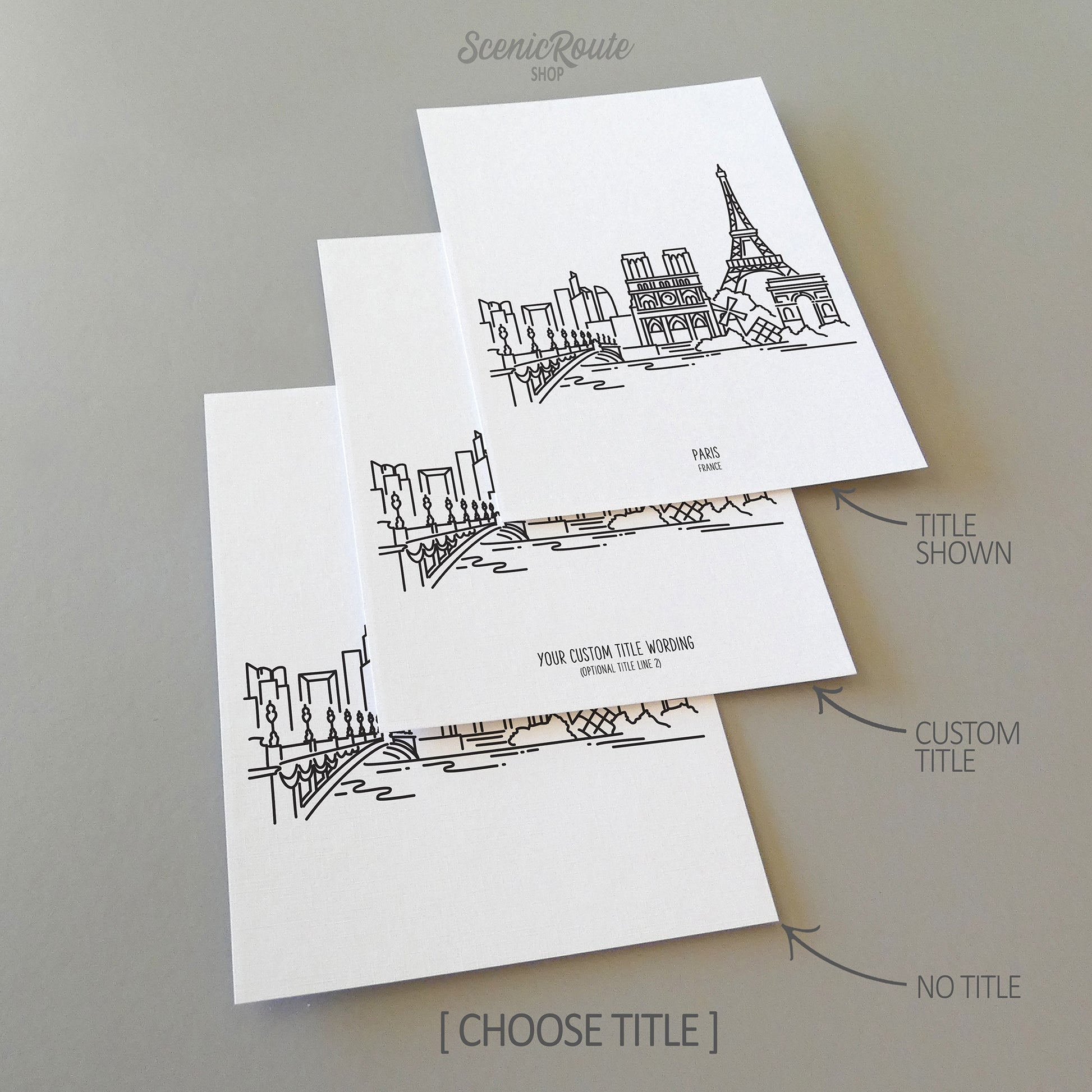 Three line art drawings of the Paris France Skyline on white linen paper with a gray background. The pieces are shown with title options that can be chosen and personalized.