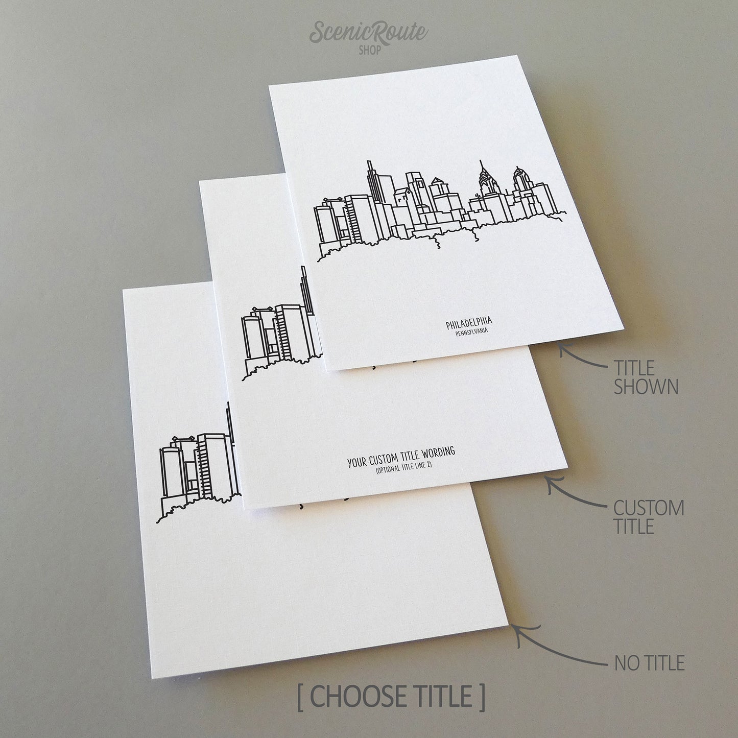 Three line art drawings of the Philadelphia Pennsylvania Skyline on white linen paper with a gray background. The pieces are shown with title options that can be chosen and personalized.