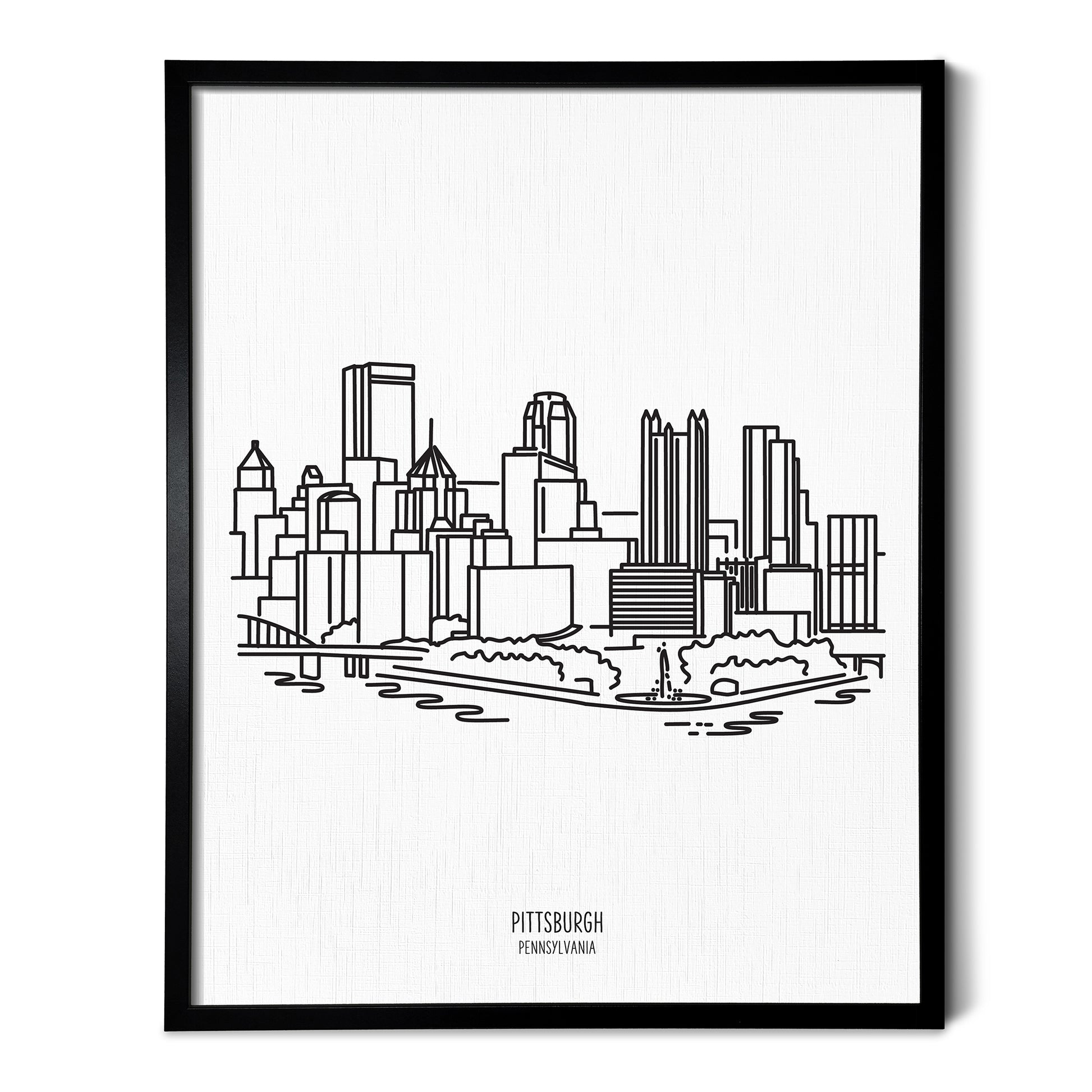 A line art drawing of the Pittsburgh Pennsylvania Skyline on white linen paper in a thin black picture frame