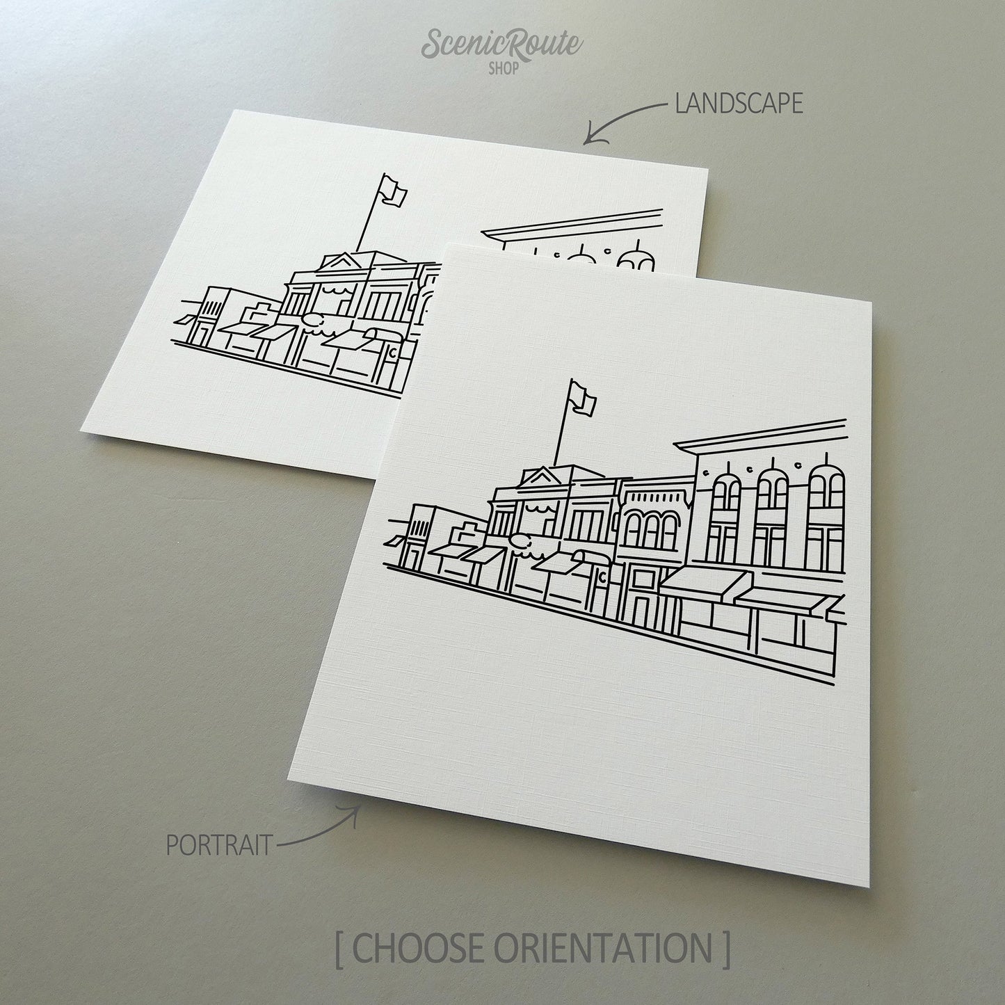 Two line art drawings of the Prescott Skyline on white linen paper with a gray background.  The pieces are shown in portrait and landscape orientation for the available art print options.