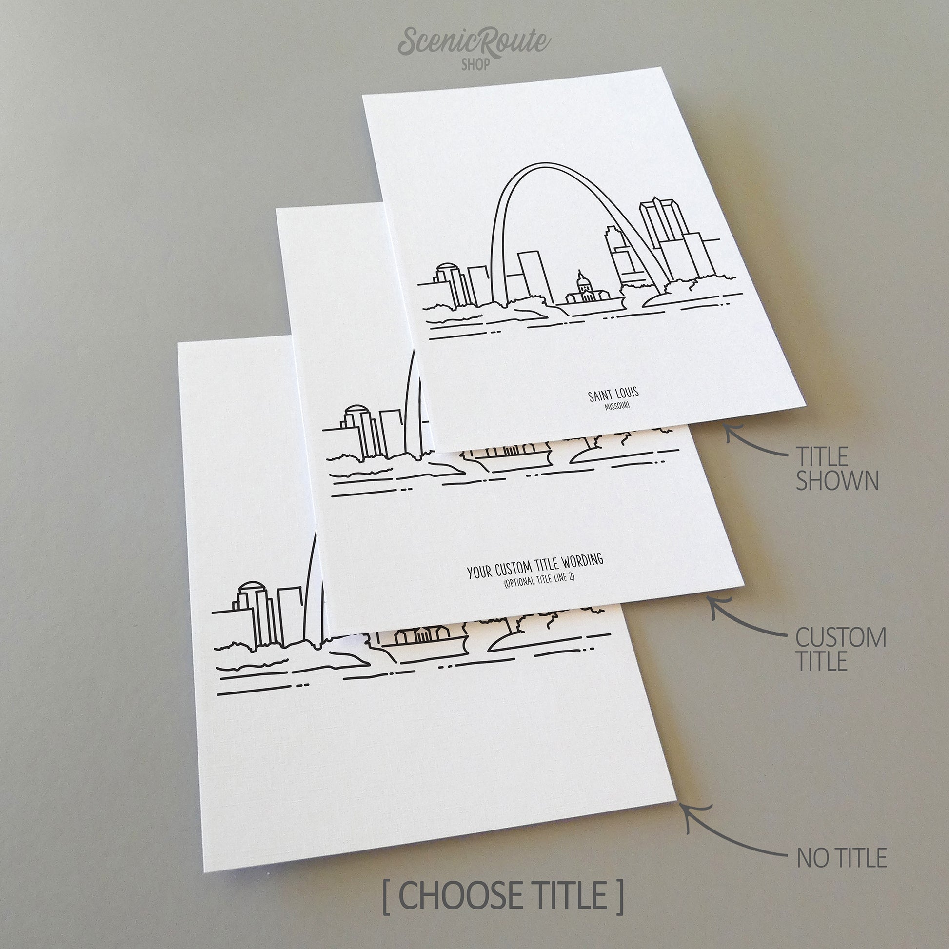 Three line art drawings of the Saint Louis Missouri Skyline on white linen paper with a gray background. The pieces are shown with title options that can be chosen and personalized.