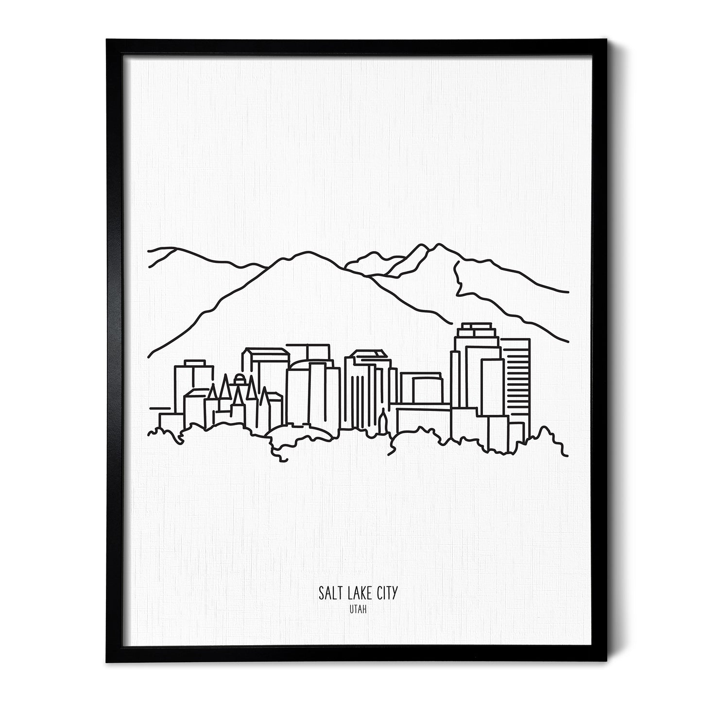 A line art drawing of the Salt Lake City Utah Skyline on white linen paper in a thin black picture frame