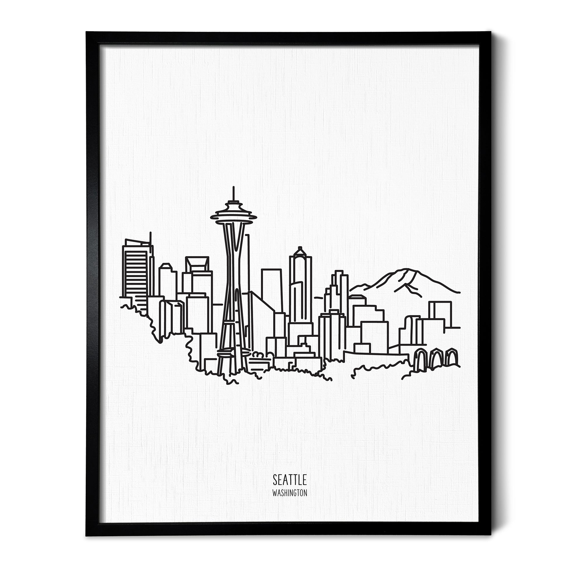 A line art drawing of the Seattle Washington Skyline on white linen paper in a thin black picture frame